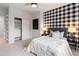 Modern bedroom featuring black and white accents, plush carpeting, closet, and soft, inviting bedding at 11364 Xavier Dr # 205, Westminster, CO 80031