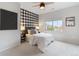 Bright bedroom with a modern black and white checkered accent wall and neutral decor, creating a calming space at 11364 Xavier Dr # 205, Westminster, CO 80031