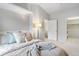 Bright bedroom with a neutral color palette, comfortable bedding, and a view into the closet at 11364 Xavier Dr # 205, Westminster, CO 80031