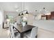 Bright dining area featuring modern lighting, adjacent to the kitchen and living room at 11364 Xavier Dr # 205, Westminster, CO 80031