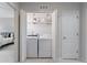 Convenient laundry closet with a side by side washer and dryer and shelving for storage at 11364 Xavier Dr # 205, Westminster, CO 80031