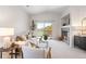 Cozy living room with a fireplace, balcony access, and ample natural light at 11364 Xavier Dr # 205, Westminster, CO 80031