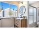 Stylish bathroom features a modern vanity, round mirror, and shower with glass doors at 186 S Nome St, Aurora, CO 80012