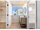 A full view of the bathroom shows the wood grain vanity, mirror and shower at 186 S Nome St, Aurora, CO 80012