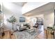 Inviting living room with light-colored walls, modern furniture, and views into the dining area at 186 S Nome St, Aurora, CO 80012