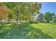 Landscaped backyard with large trees and grass at 9200 E Cherry Creek South Dr # 10, Denver, CO 80231