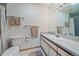 Bright bathroom featuring a toilet, vanity with a single sink, and tiled shower with curtain at 9200 E Cherry Creek South Dr # 10, Denver, CO 80231