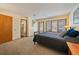 Bright bedroom featuring a bed, multiple windows, and access to an en-suite bathroom for added convenience at 9200 E Cherry Creek South Dr # 10, Denver, CO 80231