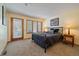 Comfortable bedroom with natural light from windows and a door, featuring a large bed and side tables at 9200 E Cherry Creek South Dr # 10, Denver, CO 80231