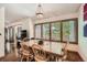 Charming dining area with a wooden table and chairs, and large windows at 9200 E Cherry Creek South Dr # 10, Denver, CO 80231