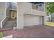 Front view of a gray townhouse with a garage and steps leading to the entrance at 9200 E Cherry Creek South Dr # 10, Denver, CO 80231