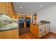 A clean kitchen boasts wooden cabinetry, granite countertops, and modern black appliances at 9200 E Cherry Creek South Dr # 10, Denver, CO 80231