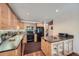 Updated kitchen with wood cabinets, granite countertops, and stainless steel appliances at 9200 E Cherry Creek South Dr # 10, Denver, CO 80231