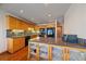 Well-equipped kitchen with warm wood cabinets, granite countertops, and modern appliances at 9200 E Cherry Creek South Dr # 10, Denver, CO 80231