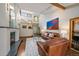 Inviting living room with a fireplace, open staircase, and large windows for abundant natural light at 9200 E Cherry Creek South Dr # 10, Denver, CO 80231