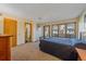 Comfortable main bedroom with a bed, large windows offering natural light, and ensuite access at 9200 E Cherry Creek South Dr # 10, Denver, CO 80231