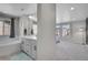 Bathroom with double vanity, soaking tub, and gray cabinets at 27891 E 7Th Ave, Aurora, CO 80018