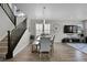 Open concept dining room with a live edge table and seating for six, view of staircase at 27891 E 7Th Ave, Aurora, CO 80018