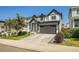 Two-story house with gray and white siding, attached garage, and landscaped front yard, viewed from the street at 27891 E 7Th Ave, Aurora, CO 80018