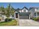 Two-story house with gray and white siding, attached garage, and landscaped front yard at 27891 E 7Th Ave, Aurora, CO 80018