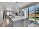 Kitchen features a large island, sliding glass door to backyard, and modern finishes at 27891 E 7Th Ave, Aurora, CO 80018