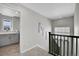 Upstairs hall with gray walls, carpet, and access to laundry room at 27891 E 7Th Ave, Aurora, CO 80018