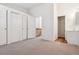 Bright Primary bedroom featuring three closets, neutral carpet, and an attached bathroom at 16104 E Alaska Pl # D, Aurora, CO 80017