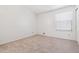 Bright bedroom with a large window, neutral carpet and trim, and clean, minimalist aesthetic at 16104 E Alaska Pl # D, Aurora, CO 80017