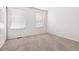 Bright bedroom with neutral carpet, two windows offering natural light, and a clean, minimalist aesthetic at 16104 E Alaska Pl # D, Aurora, CO 80017