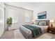 Bright bedroom with a picture window, a comfortable bed, and stylish decor at 16104 E Alaska Pl # D, Aurora, CO 80017