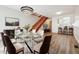 Open concept living and dining area with modern chandelier, clear table, and an adjacent kitchen at 16104 E Alaska Pl # D, Aurora, CO 80017