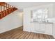 Bright kitchen area with white cabinetry and a view into the living room at 16104 E Alaska Pl # D, Aurora, CO 80017