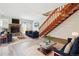 Bright living room featuring a fireplace, wood floors, modern furniture, and an eye-catching staircase at 16104 E Alaska Pl # D, Aurora, CO 80017