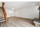 Open-concept living space features wood-look floors, a view of the kitchen, and a staircase to the second floor at 16104 E Alaska Pl # D, Aurora, CO 80017