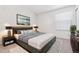 Spacious main bedroom with a modern bed, decorative lamps, and a large window at 16104 E Alaska Pl # D, Aurora, CO 80017