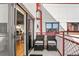 Condo outdoor balcony area with patio chairs, side table, and a view from the sliding glass door at 1435 Wazee St # 504, Denver, CO 80202