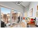Balcony sitting area with large glass doors leading to a built in bench with colorful pillows at 1435 Wazee St # 504, Denver, CO 80202
