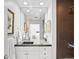 A stylish bathroom features a modern vanity, decorative mirrors, and a tiled shower area at 1435 Wazee St # 504, Denver, CO 80202