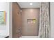Modern bathroom with tiled shower, a built-in niche, and a patterned shower curtain at 1435 Wazee St # 504, Denver, CO 80202