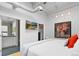 Bedroom featuring ductwork, a TV, a painting of flowers, and a view into the bathroom and closet at 1435 Wazee St # 504, Denver, CO 80202