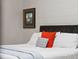 Close-up of a comfortable bed with stylish pillows and a cozy gray throw blanket at 1435 Wazee St # 504, Denver, CO 80202
