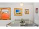 Stylish dining room with modern glass table, upholstered chairs, and colorful artwork at 1435 Wazee St # 504, Denver, CO 80202