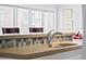 Close up of sink and breakfast bar. Windows behind bar provide great natural light at 1435 Wazee St # 504, Denver, CO 80202