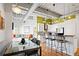 Bright kitchen with modern lighting, white cabinets, stainless steel appliances, and breakfast bar with seating at 1435 Wazee St # 504, Denver, CO 80202