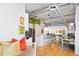Living room with a kitchen island, hardwood floors, exposed ductwork, and stainless steel appliances at 1435 Wazee St # 504, Denver, CO 80202