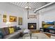 Living room featuring a fireplace, large couch, hardwood flooring and natural lighting at 1435 Wazee St # 504, Denver, CO 80202