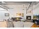 Comfortable living room with a fireplace, large couch, neutral colors and hardwood flooring at 1435 Wazee St # 504, Denver, CO 80202