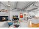 Open-concept living room with fireplace and an eat-in kitchen with stainless steel appliances at 1435 Wazee St # 504, Denver, CO 80202