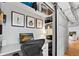 Dedicated office space with sliding barn door, built-in shelves, monitor, and a comfortable ergonomic chair at 1435 Wazee St # 504, Denver, CO 80202