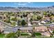 An aerial view of a neighborhood showcasing lush greenery and mountain views at 2140 S Coors Cir, Lakewood, CO 80228